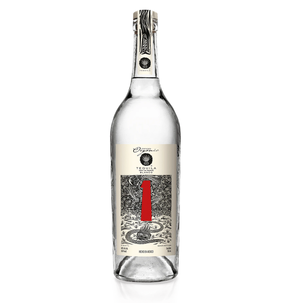 123 Organic Blanco Tequila Uno bottle with a clean, minimalist label displayed on a wooden surface, highlighting its elegant design and commitment to organic production.