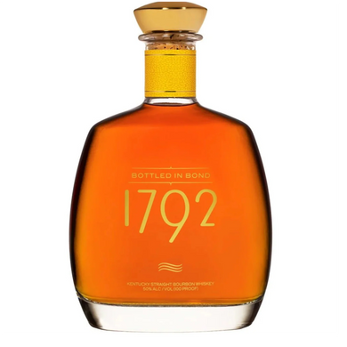 A bottle of 1792 Bottled in Bond bourbon whiskey with a golden label, sitting on a wooden surface, surrounded by a warm, rustic background.