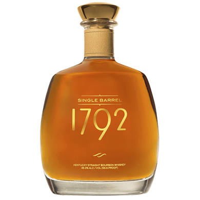 1792 Single Barrel bourbon bottle with a rich amber liquid, showcasing its elegant label and distinctive cork top, placed on a wooden surface.