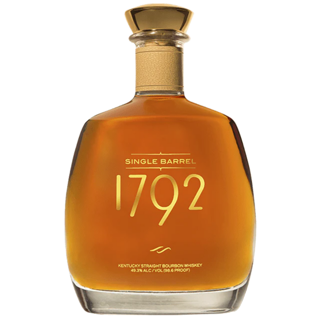 1792 Single Barrel bourbon bottle with a rich amber liquid, showcasing its elegant label and distinctive cork top, placed on a wooden surface.