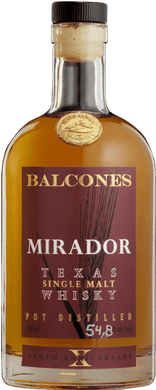 A bottle of Balcones Mirador Texas Single Malt Whisky with rich amber liquid, featuring a sleek label design, set against a rustic wooden background.